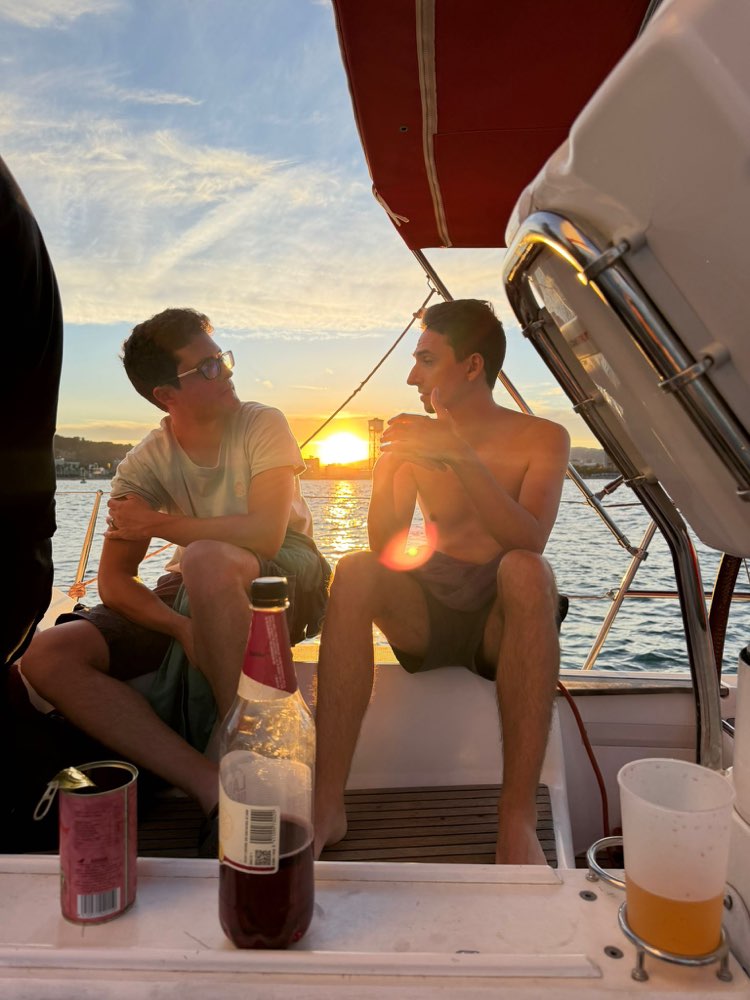 Two guests toasting on deck at sunset, Edition 02